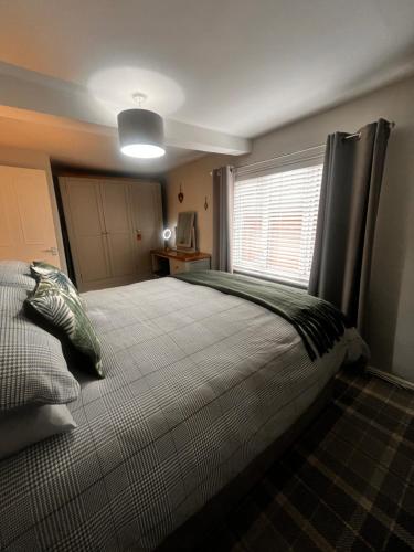 a bedroom with a large bed with a window at On Yarm High Street Great for Couples Families and Business Travel in Yarm