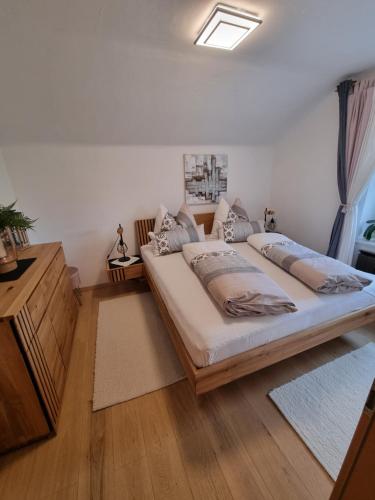 a bedroom with a large bed and a wooden dresser at Ferienwohnung Anna in Grödig