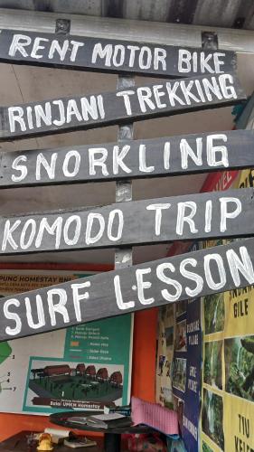 a group of signs on a wall with books at Roby Homestay in Kuta Lombok