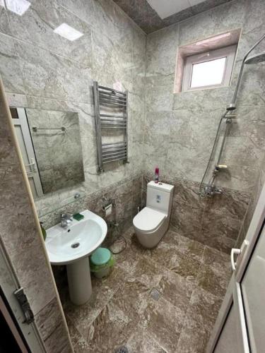 a bathroom with a sink and a toilet and a mirror at ВИЛЛА / VILLA in Gabala