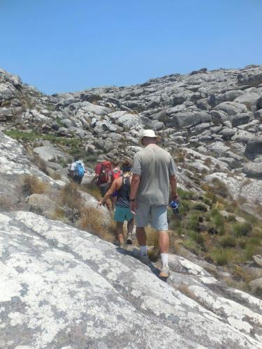 a group of people walking up a rocky mountain at Mount Mulanje Stopover in Peremwe