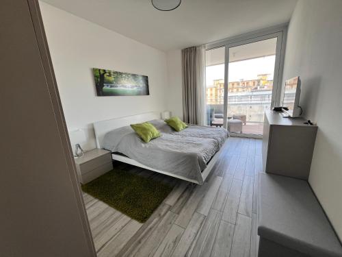 a bedroom with a bed and a large window at Palm Beach Jesolo in Lido di Jesolo