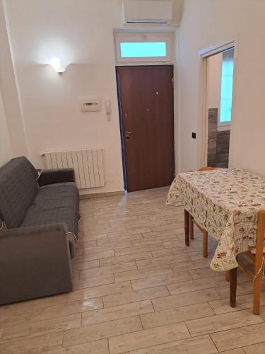 a living room with a table and a couch at Piccola Bomboniera in Gorgonzola