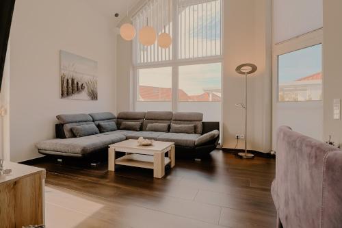 a living room with a couch and a table at Villa Große Freiheit in Trent