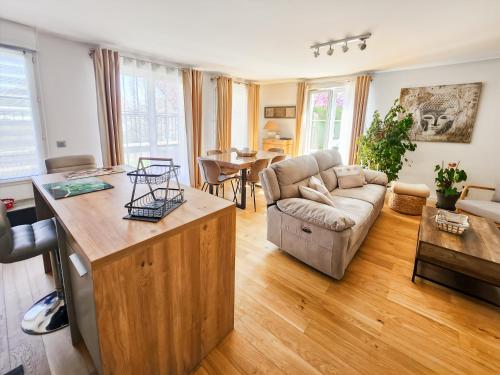 un salon avec un canapé et une table dans l'établissement Appartement cosy près Disney, jardin & terrasse, à Magny-le-Hongre