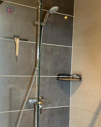 a shower with a glass door in a bathroom at Sérénité - Logement calme au coeur de Strasbourg in Strasbourg