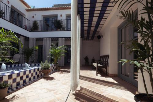 a courtyard of a house with plants and a balcony at Nomad Hotel & Spa Altea in Altea