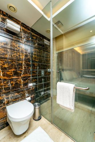 a bathroom with a glass shower and a toilet at Country Inn & Suites By Radisson, Bengaluru Hebbal Road in Bengaluru