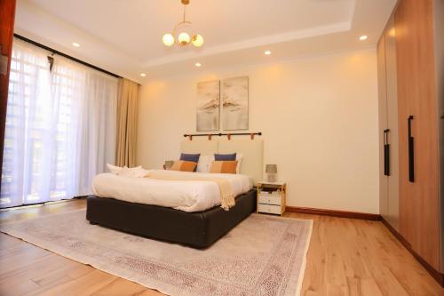 a bedroom with a large bed and a rug at Yunia Luxury 1-Bed Apartment in Busia