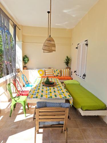 a living room with a table and a couch at colored houses in Ierapetra