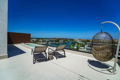 a patio with chairs and a chandelier on a building at Marina Garden Cap Cana by Beach Homes Punta Cana in Punta Cana