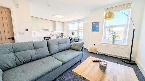 a living room with a couch and a table at Llandudno Lounge by Seaside Llandudno in Llandudno