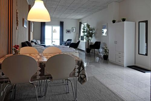 a dining room and living room with a table and chairs at Bogense Feriebo in Bogense