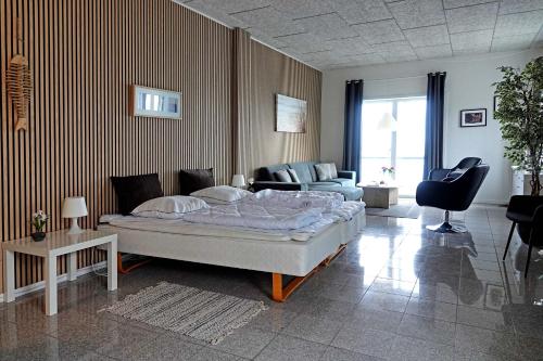a bedroom with a bed and a living room at Bogense Feriebo in Bogense