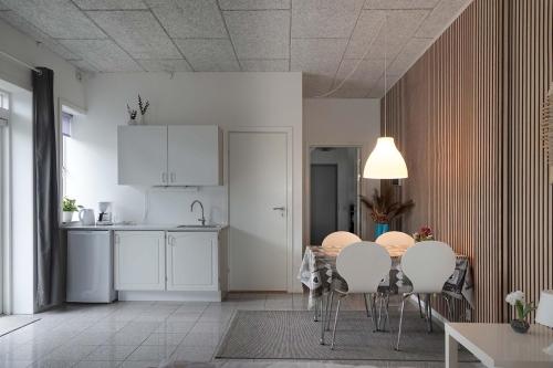 a kitchen and dining room with a table and chairs at Bogense Feriebo in Bogense