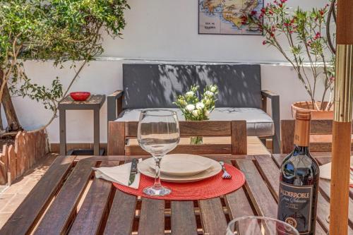 a table with a wine glass and a plate on it at Sweet Family House in Cala d´Or