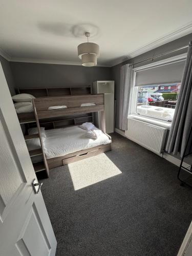 a bedroom with a bunk bed and a window at 3 bedroom house, Caol, Fort William in Caol