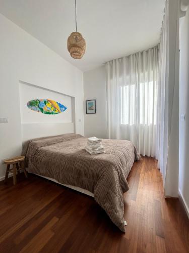 a bedroom with a large bed in a white room at Limone Al Mare in Albenga
