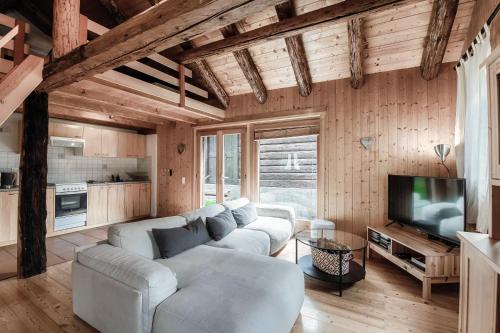 a living room with two couches and a television at Romantic Chalet in the Leventina Mountains by Quokka 360 - Romantic Chalet in Faido