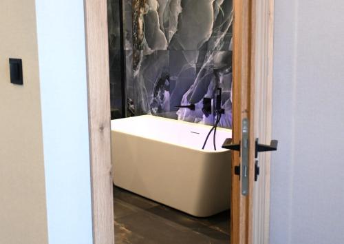 a bathroom with a bath tub in a room at Hotel Centrum Malbork in Malbork
