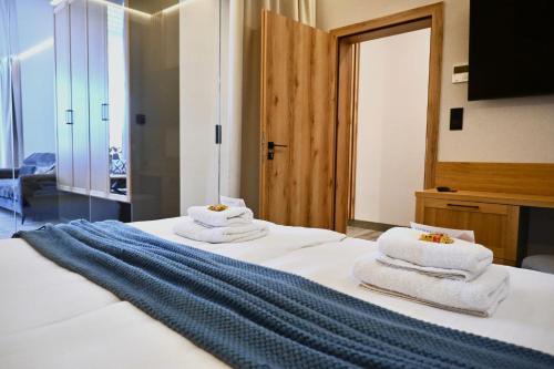 a bedroom with a bed with towels on it at Hotel Centrum Malbork in Malbork