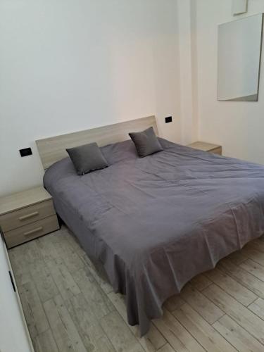a large bed with two pillows on it in a bedroom at Piccola Bomboniera in Gorgonzola
