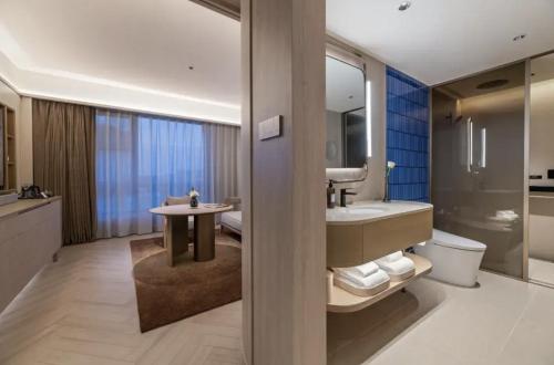 a bathroom with a sink and a toilet at Crystal Orange Hotel Shanghai Chongming Nanmen in Shanghai