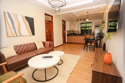 a living room with a couch and a table at Yunia Luxury 1-Bed Apartment in Busia