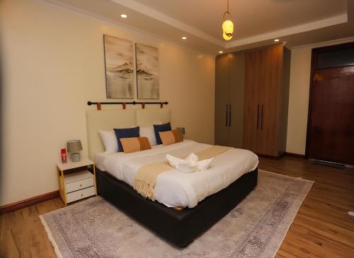 a bedroom with a large bed in a room at Yunia Luxury 1-Bed Apartment in Busia
