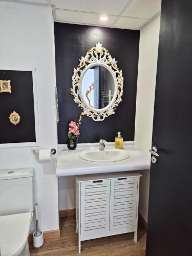 une salle de bain avec un lavabo et un miroir dans l'établissement Céleste Premium Suite Amazing View Train Station, à Lourdes