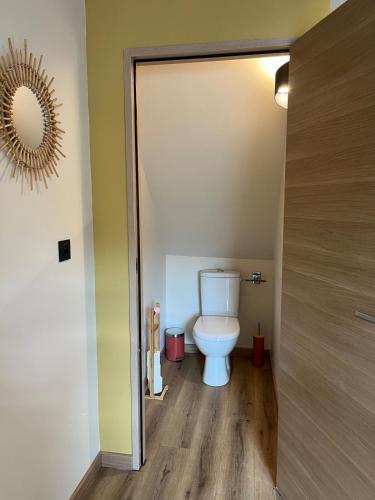 a bathroom with a white toilet in a room at Gîte 4 de l être aux Rues in Chailloué