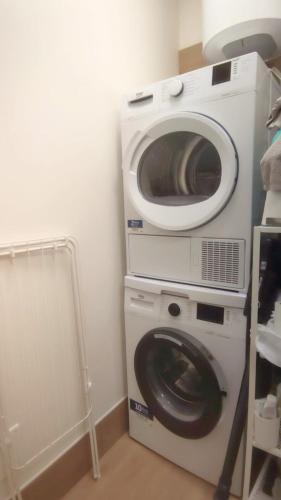 a washing machine and a washer in a room at Ariminum Suite - Minimalism and class in the historic center in Rimini