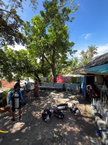 a group of people standing around a group of motorcycles at Mario's Scuba Diving and Homestay in Apo Island