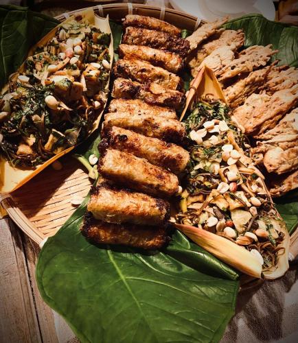 a plate of food on a green leaf at maison Rose & Jardinier eco homestay in Sa Pa