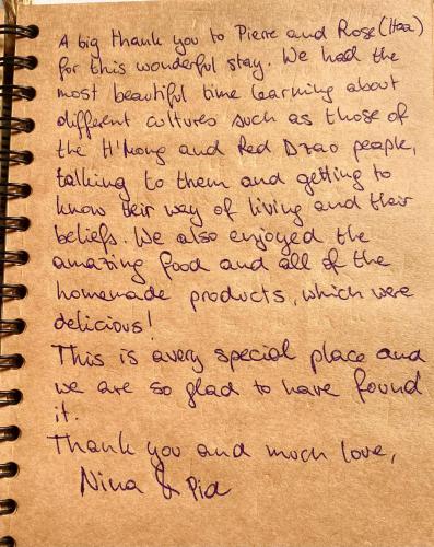 a letterzos writing in a notebook at maison Rose & Jardinier eco homestay in Sa Pa