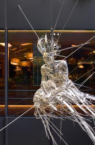 a glass sculpture of a woman in a window at ME Barcelona in Barcelona