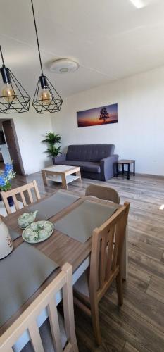 a living room with a table and a couch at Chodov apartmán in Prague