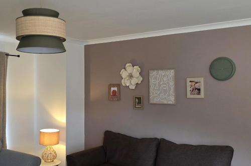 a living room with a couch and a wall with pictures at The Ansi9 in Livingston