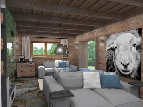 a living room with a couch and a picture of a sheep at Resort Drevenice Terchova in Terchová