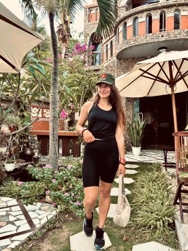 a woman is standing on a step in a garden at Sầm Sơn Boutique Hotel Phan Thiết in Phan Thiet