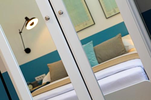 a mirror in a room with a bed at Vacation Home Villa Oleandra in Bol