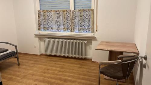 a room with a window and a table and a chair at Ferienwohnung Spelle in Spelle