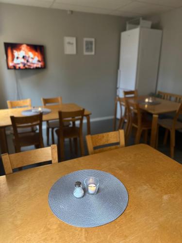 a table with a plate and two cups on it at Borrgården Hostel in Ljusdal