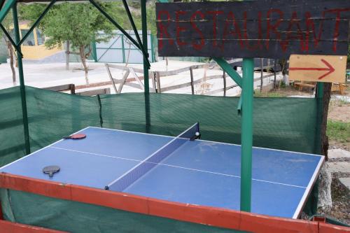 a ping pong table with a sign on top of it at Chorvoq View in Chorwoq