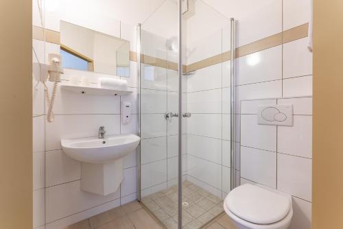 a bathroom with a toilet and a sink and a shower at OEKOTEL Salzburg Messe in Salzburg