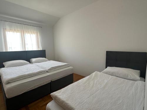 a bedroom with two beds and a window at Apartment Jure in Međugorje
