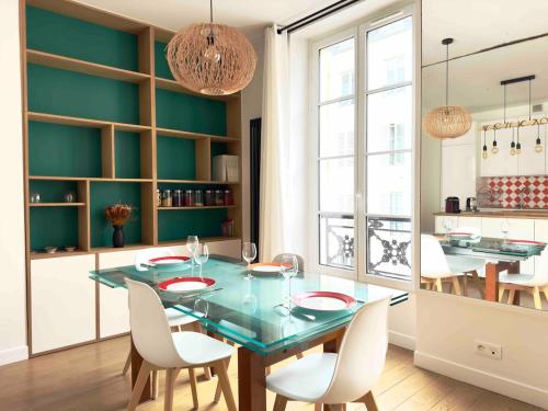une salle à manger avec une table en verre et des chaises blanches dans l'établissement Spacious 4P Apartment Madeleine Department Stores, à Paris