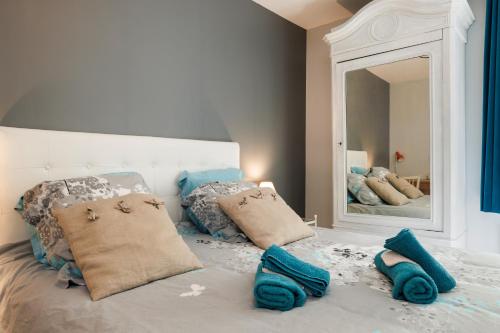 a bedroom with a bed with a large mirror at La Longere Chateau Vieux Mougnac in Petit-Palais-et-Cornemps