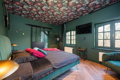 a bedroom with a bed with a floral ceiling at The Music Suites in Bruges