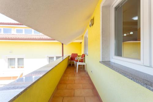 a balcony with two chairs and a window at Apartma Majdas in Loka pri Mengšu